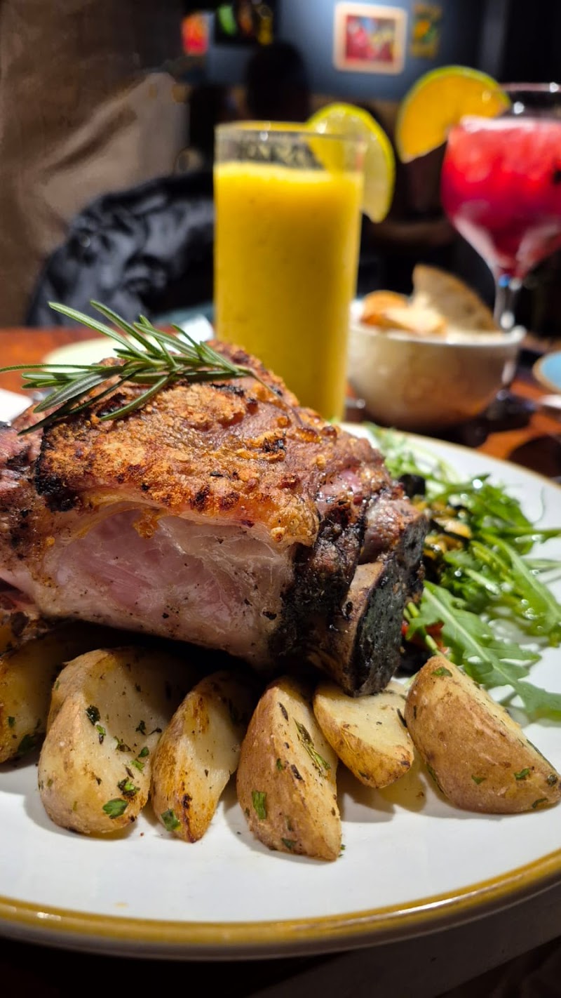 Herb-roasted meat with potatoes and fresh juice at Di Martina
